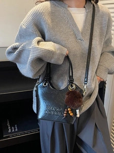 Retro minimalist black bucket bag with plush charm and chic double handles for women
