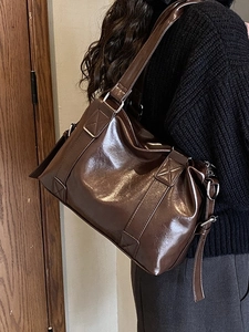 Vintage dark brown oil wax leather tote bag with glossy finish and wide shoulder strap