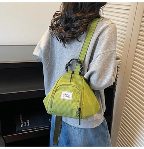 Detailed view of the lime green checkered canvas material and teardrop-shaped bag design