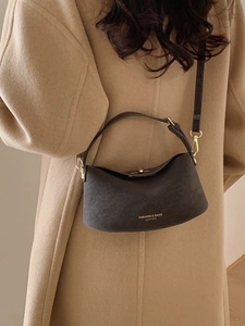 Minimalist leather bucket bag in dark grey with golden hardware for stylish women
