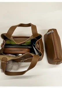 Internal view of brown litchi leather bucket bag set with inner pouch and accessories