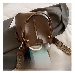 Interior view of brown leather bucket bag showing capacity for phone and cosmetics