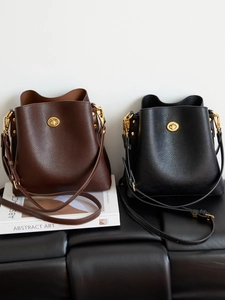 Retro pebbled leather bucket bags in dark brown and black with gold oval turn-lock hardware
