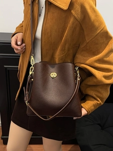 Vintage dark brown pebble leather bucket bag with gold lock buckle and shoulder strap