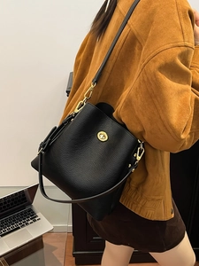 Classic black litchi pattern leather bucket bag with gold oval twist lock closure