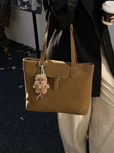 Retro brown leather tote bag with plush puppy charm for women daily commuting fashion