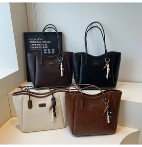 Multi-colored PU leather tote bags with wooden bead charms displayed on a tiered stand