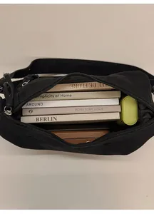 Interior view of black canvas crossbody bag showing large capacity and internal space