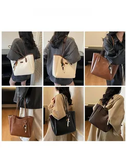 Litchi pattern PU leather tote bag shown in four colors with decorative beaded pendant