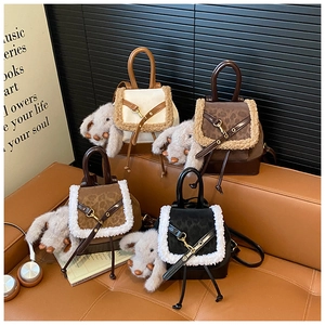 Detail of four faux fur plush mini backpacks with cute puppy charms in various colors