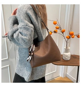 Brown litchi leather hobo bag with floral silk scarf accessory and adjustable strap