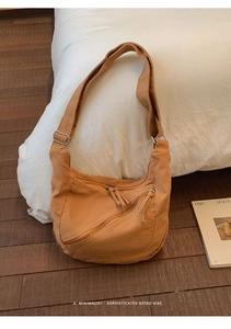 Close-up of mustard yellow canvas crossbody bag featuring retro zipper and fringe details