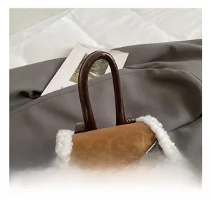 Close-up of the comfortable brown leather handle and white plush trim of the backpack