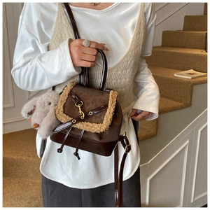 Detail of mini vintage backpack with brown leather, leopard pattern, and plush toy charm