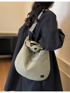 Olive green padded crossbody bag worn by model, showcasing large capacity and soft texture