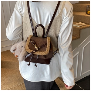 Close-up of leopard print retro backpack with faux fur trim and cute rabbit pendant