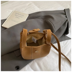 Detailed top view of brown bucket bag showing magnetic closure and interior branding mark