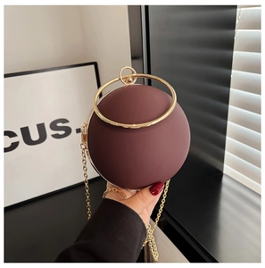 Chic burgundy acrylic sphere evening bag with golden circular handle and chain strap