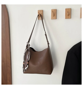 Detail of dark brown lychee leather hobo bag with printed silk scarf and wooden beads
