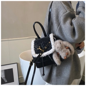 Detail of mini black backpack with leopard print flap, faux fur trim and grey bunny charm