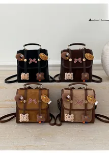 Flat lay of four vintage suede backpacks in black, brown, caramel and beige colors