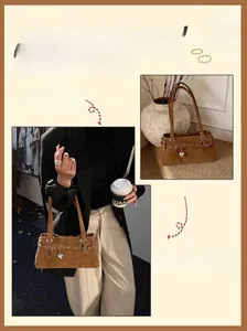 Detail view of brown suede Boston bag featuring metallic star pendants and a chic buckle