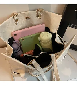 Top view of white quilted tote bag interior showing large capacity for essentials