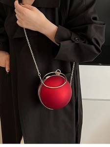Spherical dark red acrylic evening bag with gold ring handle and metal chain strap