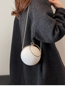 Elegant white spherical acrylic evening bag with gold ring handle and crossbody chain