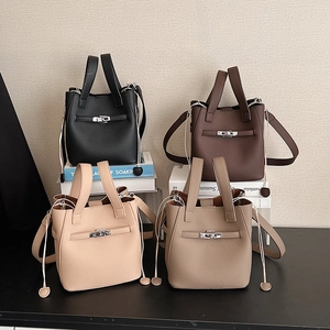 Litchi pattern leather bucket bags in four colors with drawstring and metal buckle detail