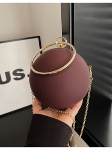 Spherical burgundy acrylic evening bag with golden ring handle and chain strap for women