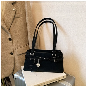 Detail of black vintage Boston bag featuring heart and star metallic charms on matte fabric