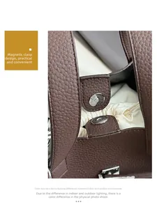 Detail of brown lychee leather handbag featuring a magnetic snap and drawstring inner pouch