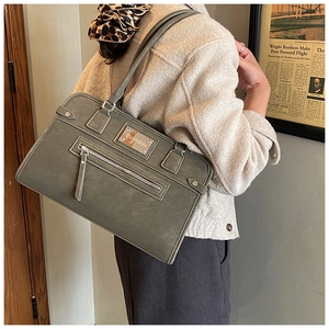 Detailed side view of matte grey rectangular shoulder bag showing smooth texture and size