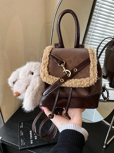 Vintage brown leather backpack with cream faux fur trim and cute rabbit pendant