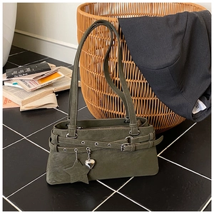 Detail of dark green frosted leather handbag with star charms and silver metal eyelets
