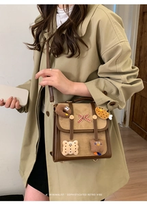 Retro brown crossbody bag detail with plaid bow and cute cartoon charms on suede finish