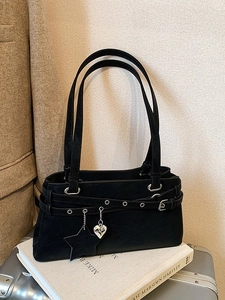 Black vintage Y2K Boston bag with star and heart charms on a white book base