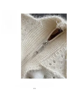Macro detail of silver metal zipper on white knitted faux fur tote bag for women