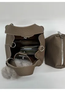 Top view of brown leather bucket bag showing inner capacity with accessories