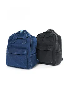Detailansicht von gewaschenen Denim-Rucksäcken in Marineblau und Anthrazitschwarz