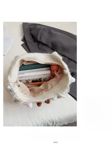 Spacious interior of white plush knit tote bag showing zipper closure and large capacity