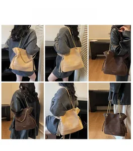 Multiple views of a large suede bucket bag with gold chain strap and stitching detail
