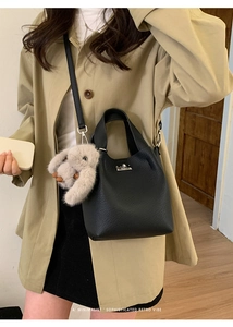 Black pebbled leather bucket bag with silver twist lock and cute grey plush bunny charm