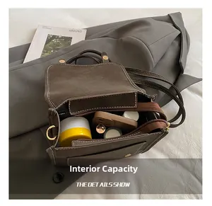 Interior view of vintage brown suede bag showing storage space for phone and makeup