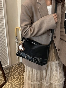 Vintage black tote bag with silver buckle details and heart mirror charm on model