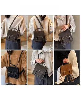 Close-up of vintage faux leather backpack showing magnetic buckle and matte texture