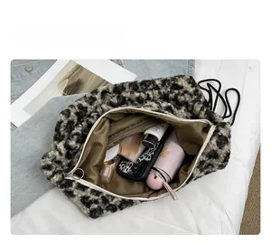 Detailed interior space of plush leopard print tote bag with items for daily use