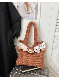 Detail of hollow knit tote bag featuring five cute miniature plush cats on the rim