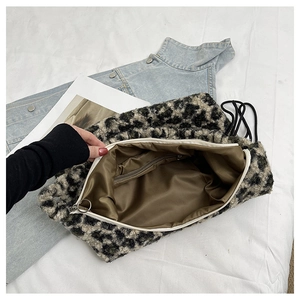 Detail of plush leopard print shoulder bag showing interior lining and zipper pocket